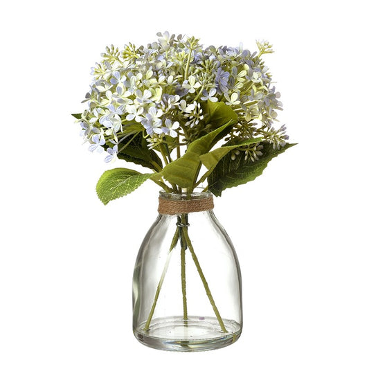 Pale Blue Flowers In Clear Glass Vase